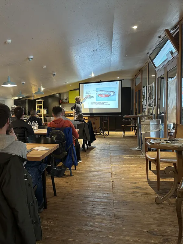 Volles Kurslokal in Bülach, vorne erklärt der Instruktor an der Leinwand den Theorieteil